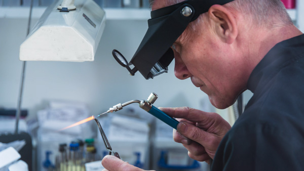 Image: A jewelry craftsman uses a blowtorch to work on a platinum setting.