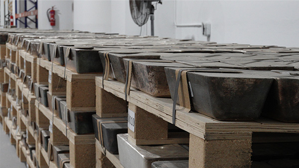 Image: A stack of dirty, tarnished silver bars.